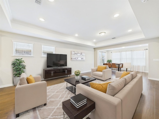 7652 Monument Dr, Little Elm, TX 76227 - living area featuring a tray ceiling, crown molding, wood finished floors, and recessed lighting