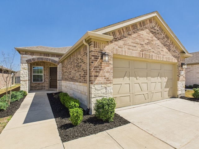 view of front of house with a garage, brick siding, a shingled roof, and driveway