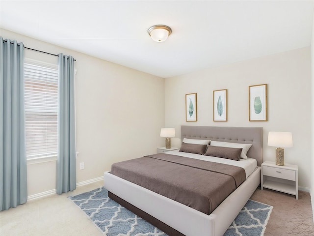 carpeted bedroom featuring baseboards