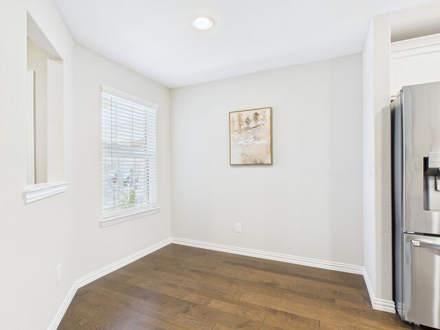 unfurnished dining area featuring baseboards, recessed lighting, and dark wood-style flooring