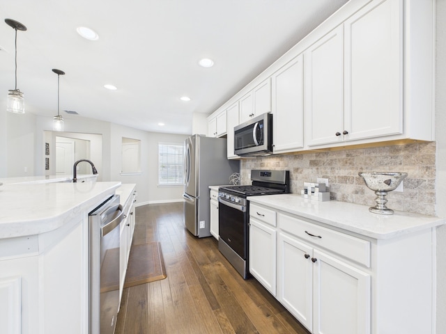 kitchen featuring white cabinetry, stainless steel appliances, and tasteful backsplash