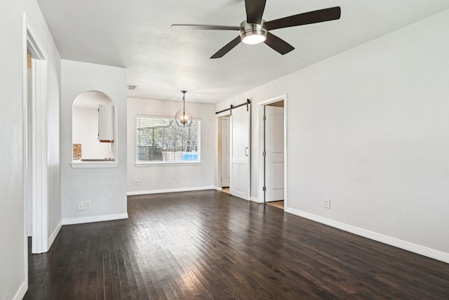 10319 Sylvia Dr, Dallas, TX 75228 - unfurnished living room with a barn door, wood finished floors, ceiling fan, and baseboards