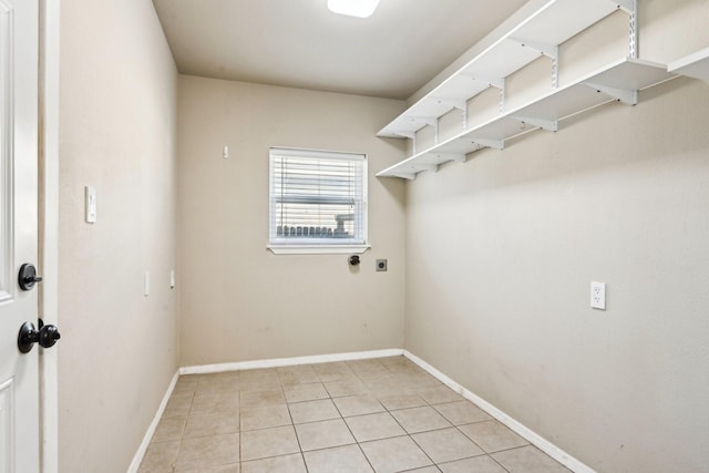 10319 Sylvia Dr, Dallas, TX 75228 - laundry area featuring light tile patterned flooring, electric dryer hookup, and baseboards