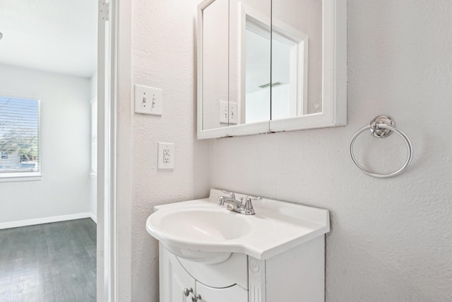 10319 Sylvia Dr, Dallas, TX 75228 - bathroom with wood finished floors and vanity