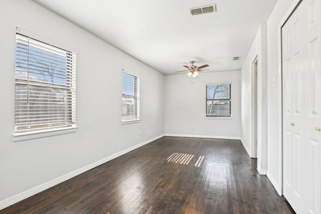 10319 Sylvia Dr, Dallas, TX 75228 - empty room with dark wood-style flooring, ceiling fan, and baseboards