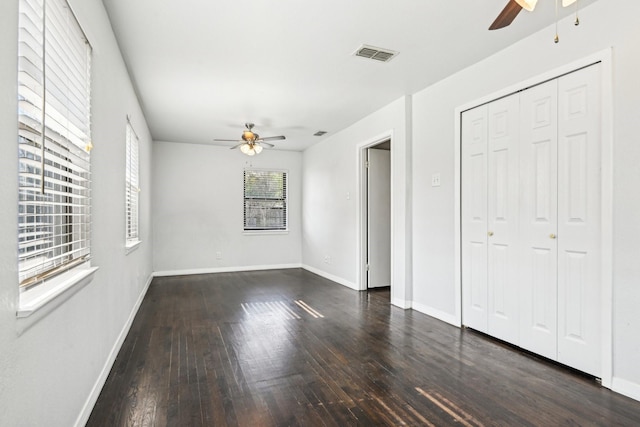 10319 Sylvia Dr, Dallas, TX 75228 - unfurnished bedroom featuring wood-type flooring, baseboards, a ceiling fan, and a closet