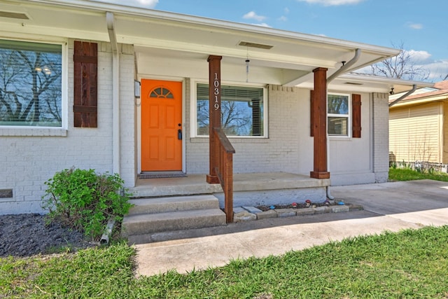 10319 Sylvia Dr, Dallas, TX 75228 - doorway to property with brick siding and covered porch