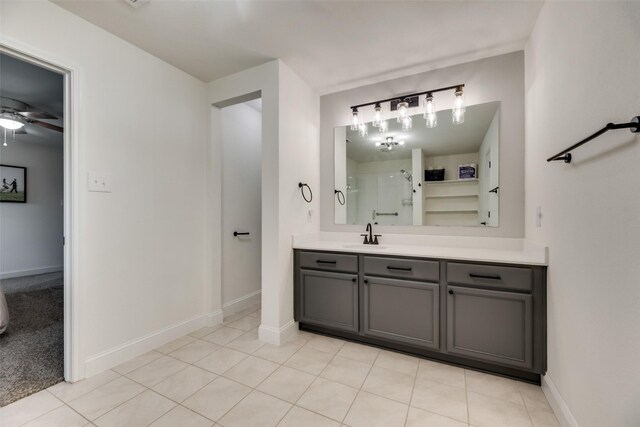 2282 Torch Lake Dr, Forney, TX 75126 - full bathroom with tile patterned floors, vanity, a ceiling fan, a shower stall, and baseboards