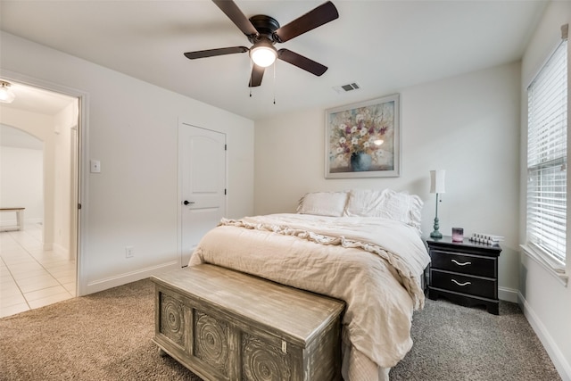 2282 Torch Lake Dr, Forney, TX 75126 - bedroom featuring tile patterned flooring, baseboards, visible vents, arched walkways, and carpet
