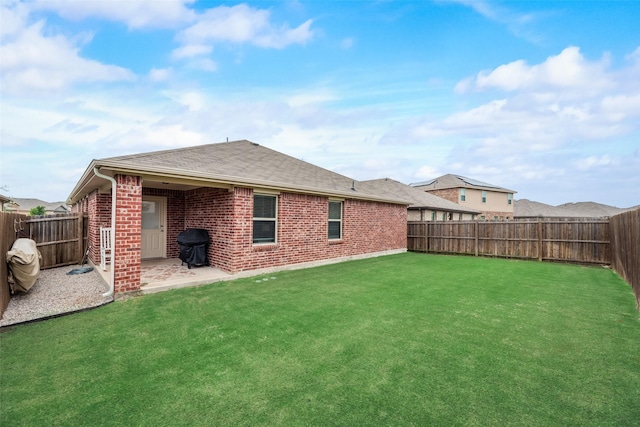 2282 Torch Lake Dr, Forney, TX 75126 - rear view of property with a fenced backyard, brick siding, and a yard