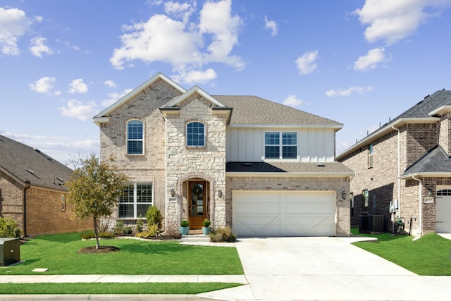 16509 Hidden Cove Dr, Celina, TX 75009 - french country home with board and batten siding, driveway, a front yard, a garage, and roof with shingles