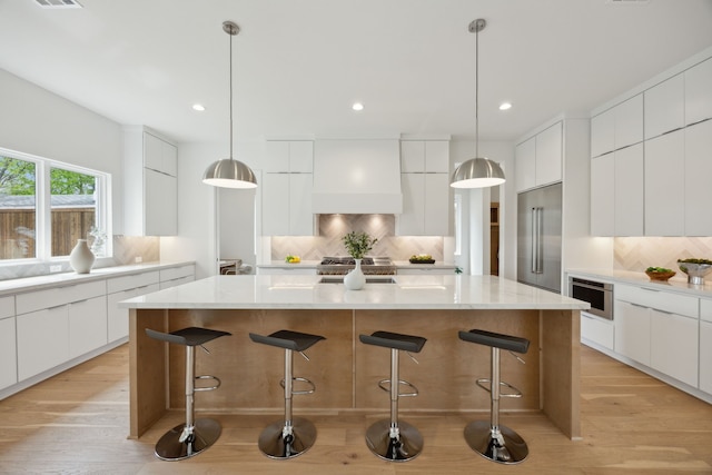 kitchen with modern cabinets, appliances with stainless steel finishes, and tasteful backsplash