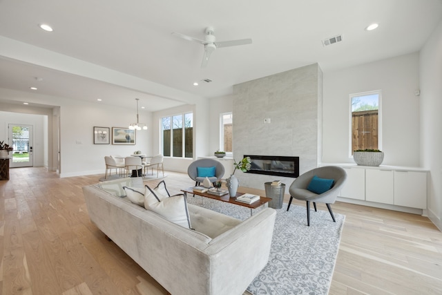 living room featuring visible vents, a healthy amount of sunlight, and recessed lighting