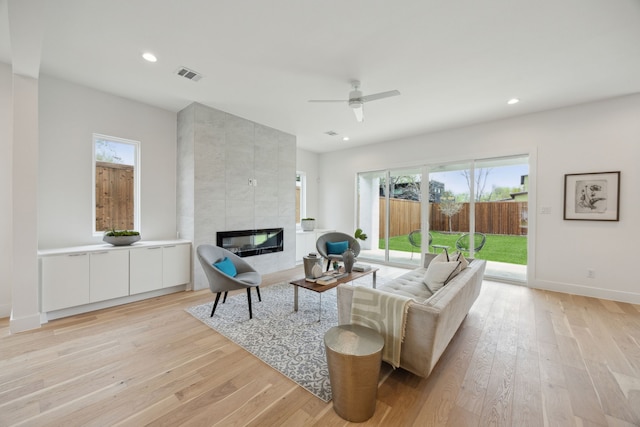 living area featuring visible vents, a healthy amount of sunlight, and light wood finished floors