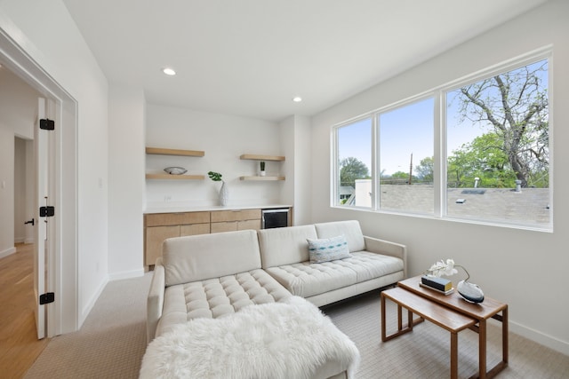 living room with light wood-style floors, wine cooler, recessed lighting, and baseboards