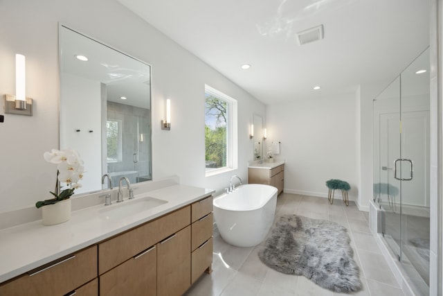 full bath featuring a shower stall, a wealth of natural light, and a sink