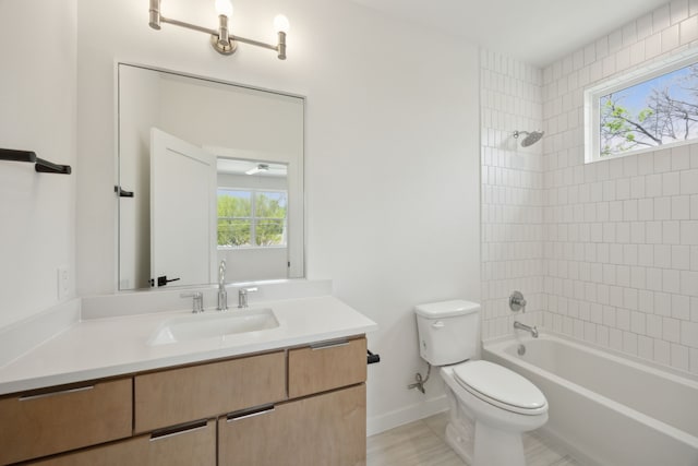 bathroom with toilet, shower / washtub combination, vanity, and plenty of natural light
