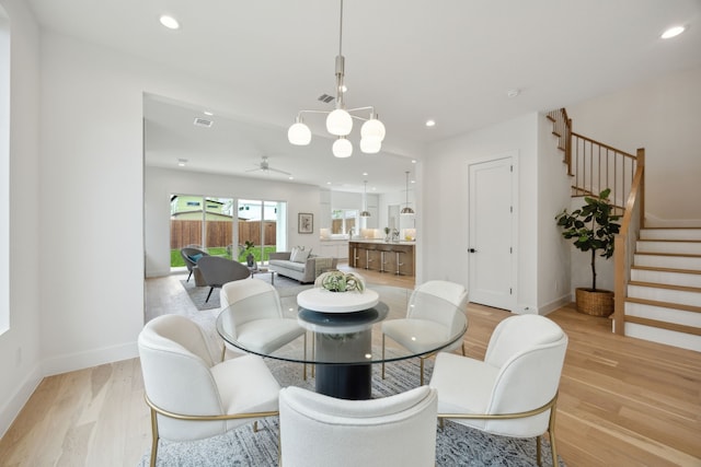 dining room with ceiling fan, baseboards, recessed lighting, light wood finished floors, and stairs