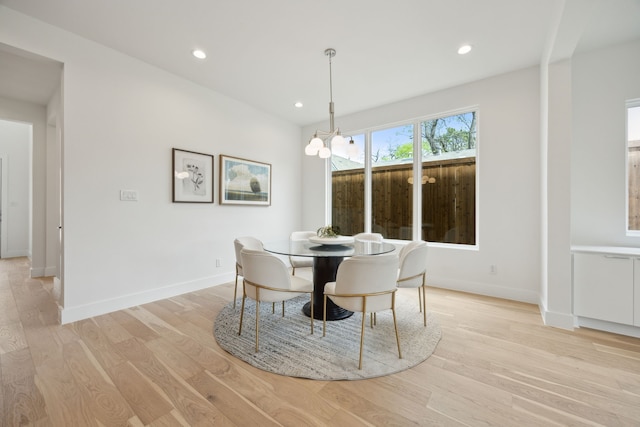 dining area featuring baseboards, recessed lighting, a notable chandelier, and light wood-style flooring