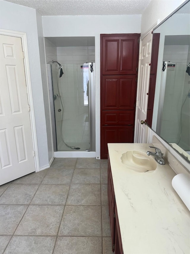 901 Freestone Ct, Arlington, TX 76017 - full bathroom with a textured ceiling, a stall shower, and vanity