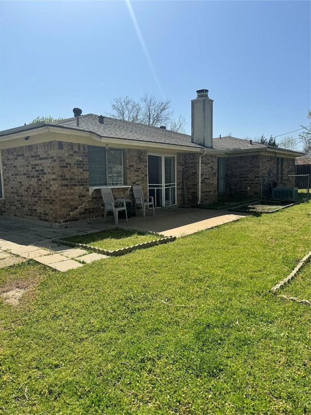 901 Freestone Ct, Arlington, TX 76017 - rear view of property with a lawn, a chimney, a patio, and brick siding