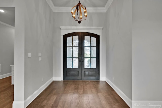 1113 Forest Trail Dr, Shreveport, LA 71106 - entrance foyer with crown molding, dark wood-type flooring, a chandelier, french doors, and arched walkways