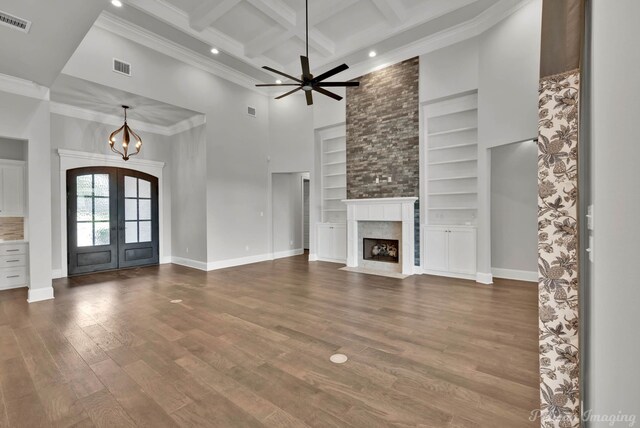 1113 Forest Trail Dr, Shreveport, LA 71106 - unfurnished living room with french doors, a high ceiling, beam ceiling, recessed lighting, and built in shelves