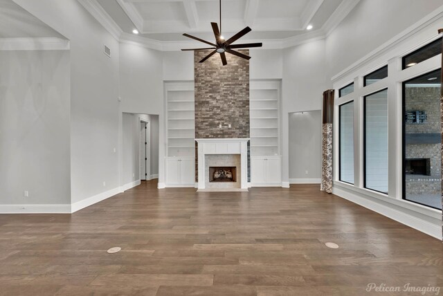 1113 Forest Trail Dr, Shreveport, LA 71106 - unfurnished living room with a premium fireplace, ceiling fan, built in features, a high ceiling, and beam ceiling