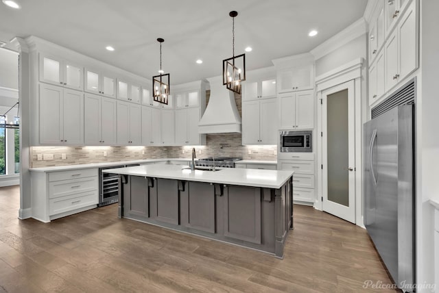 1113 Forest Trail Dr, Shreveport, LA 71106 - kitchen with built in appliances, premium range hood, light countertops, white cabinets, and backsplash