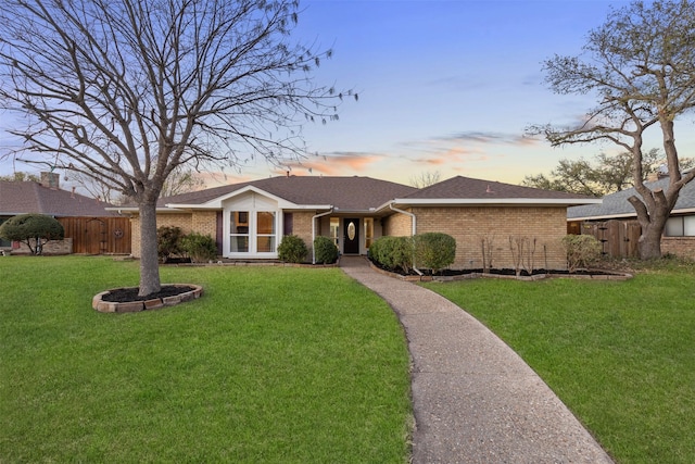 view of front of house featuring brick siding and roof with shingles