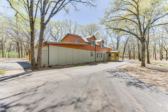 view of home's exterior with aphalt driveway
