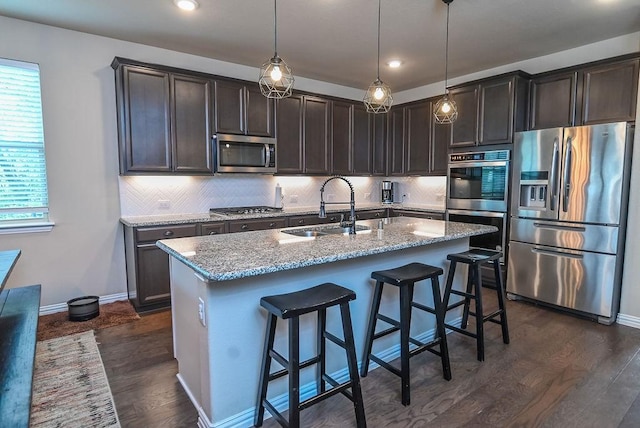 201 Virginia Ln, Hickory Creek, TX 75065 - kitchen with stainless steel appliances, dark brown cabinetry, light stone counters, dark wood-type flooring, and backsplash