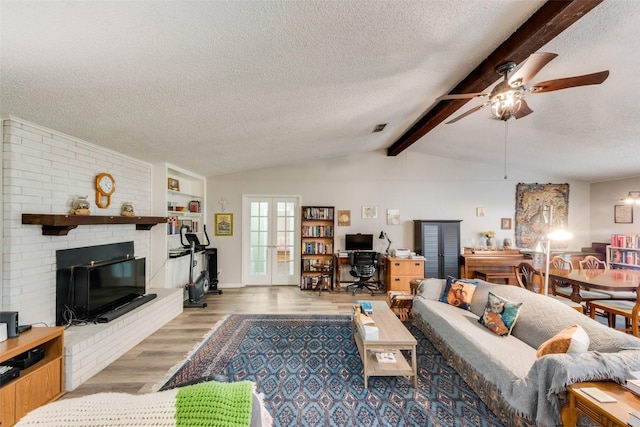 living area featuring lofted ceiling with beams, french doors, visible vents, ceiling fan, and wood finished floors