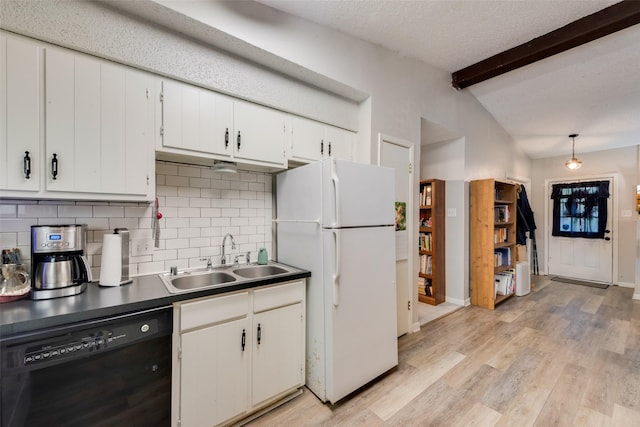 kitchen featuring dishwasher, a sink, freestanding refrigerator, light wood finished floors, and vaulted ceiling with beams