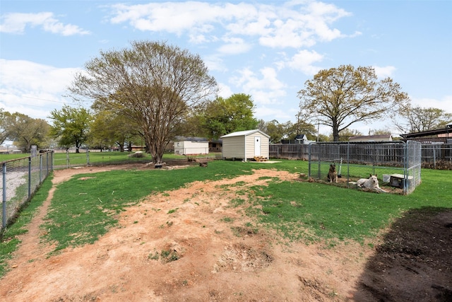 view of yard with a fenced backyard, a storage unit, and an outdoor structure