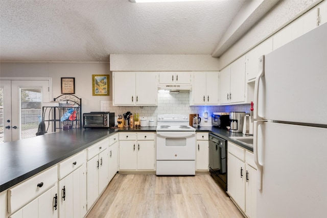 kitchen with light wood-style flooring, under cabinet range hood, dark countertops, and white appliances