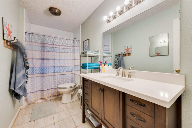 bathroom featuring a shower with shower curtain, toilet, a textured ceiling, vanity, and tile patterned flooring