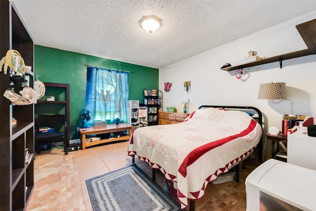 tiled bedroom with a textured ceiling