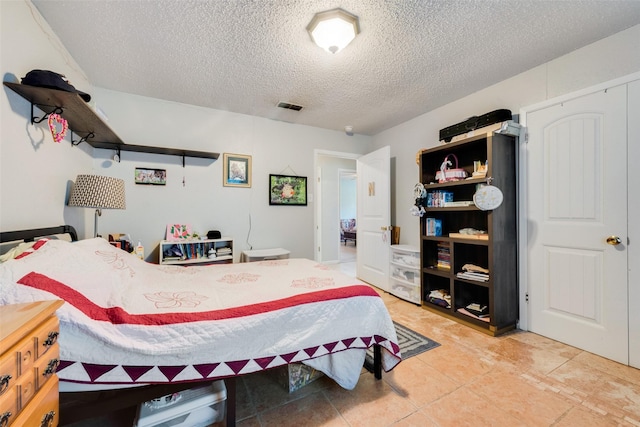bedroom with visible vents and a textured ceiling