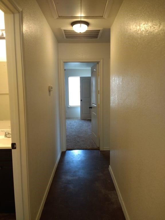 8124 Doreen Ave, Fort Worth, TX 76116 - hall with a sink, attic access, baseboards, visible vents, and a textured wall