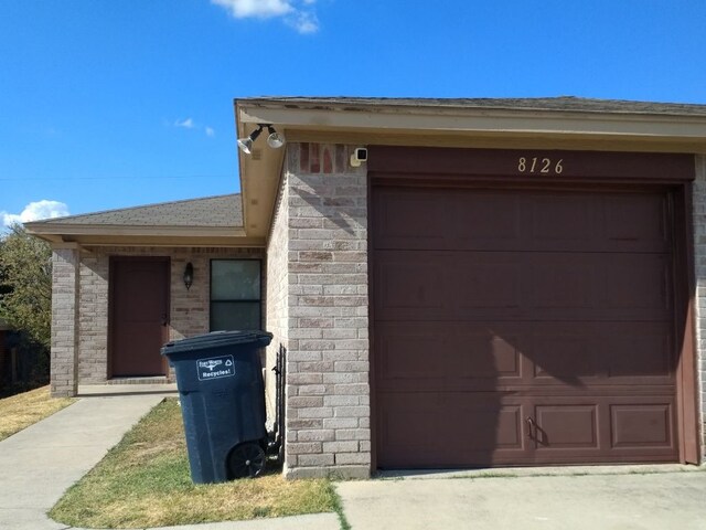 8124 Doreen Ave, Fort Worth, TX 76116 - exterior space featuring brick siding, a shingled roof, and a garage