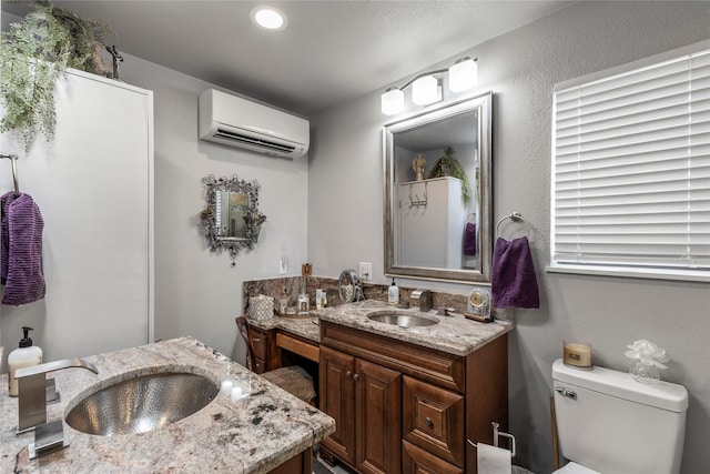 bathroom with recessed lighting, toilet, vanity, and a wall unit AC