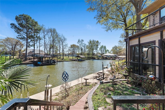 dock area featuring a water view and a balcony
