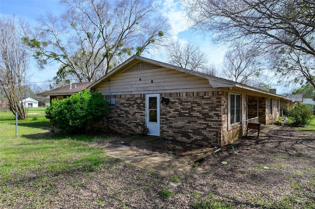 210AND218 N Collins, Colbert, OK 74733 - view of side of property with brick siding and a yard
