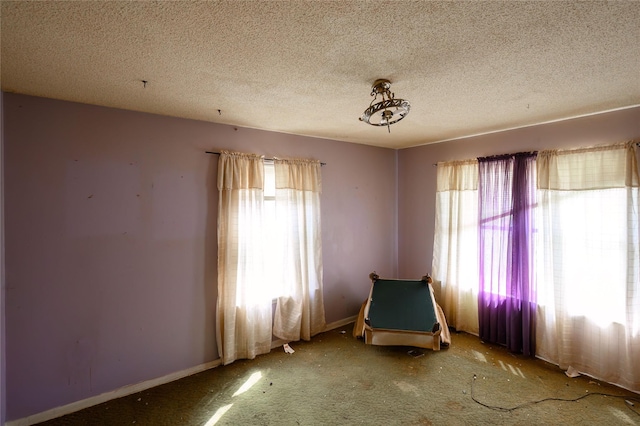 210AND218 N Collins, Colbert, OK 74733 - unfurnished bedroom with baseboards, carpet floors, and a textured ceiling