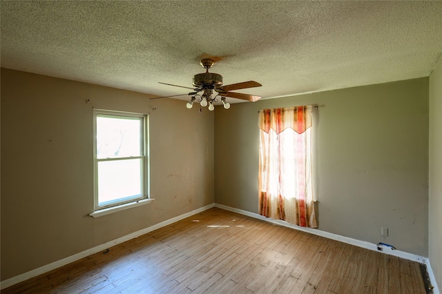 210AND218 N Collins, Colbert, OK 74733 - unfurnished room with a wealth of natural light, wood finished floors, ceiling fan, and baseboards