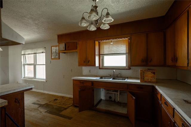210AND218 N Collins, Colbert, OK 74733 - kitchen with brown cabinets, light countertops, a sink, and wood-type flooring