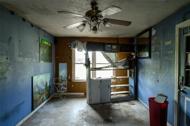 210AND218 N Collins, Colbert, OK 74733 - spare room featuring baseboards, a textured ceiling, unfinished concrete floors, and a ceiling fan