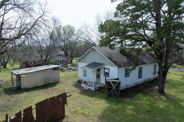 210AND218 N Collins, Colbert, OK 74733 - rear view of property featuring a shingled roof, fence, and a yard