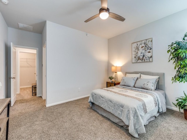 carpeted bedroom featuring baseboards, ceiling fan, and visible vents
